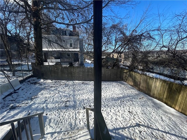 view of yard layered in snow