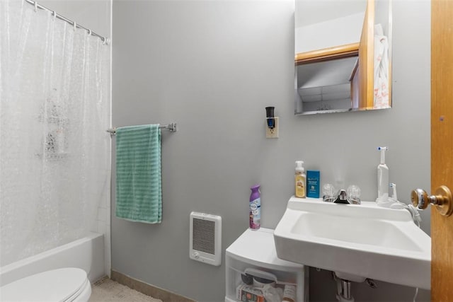 full bathroom featuring toilet, shower / tub combo with curtain, sink, and heating unit