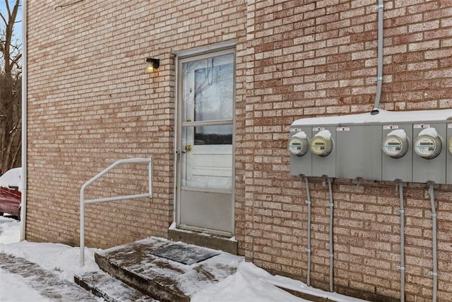 view of snow covered property entrance