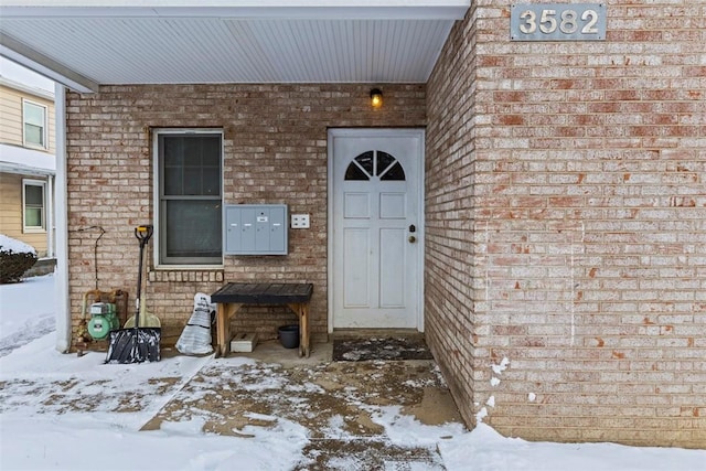 view of snow covered property entrance