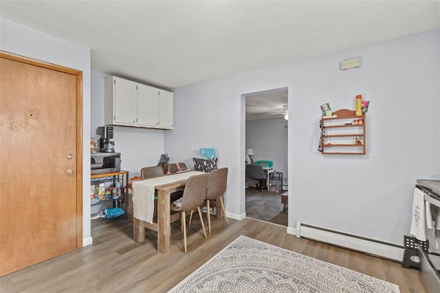 dining room featuring light hardwood / wood-style floors and a baseboard radiator