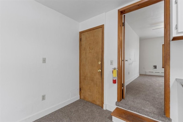 hall featuring light carpet and a baseboard heating unit