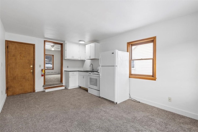 kitchen with light carpet, sink, white appliances, and white cabinetry