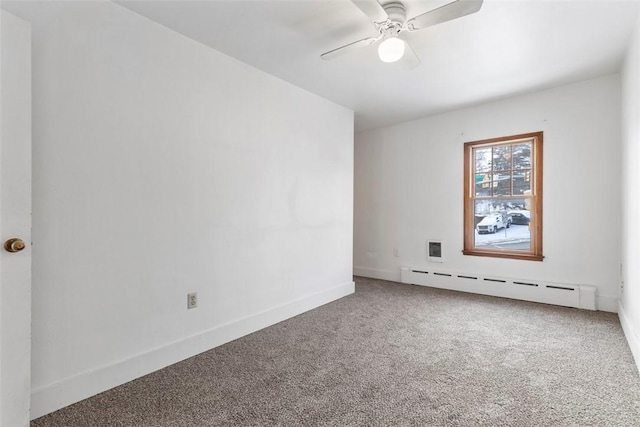 carpeted empty room featuring ceiling fan and baseboard heating