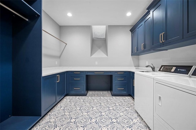 laundry room featuring cabinets, washer and clothes dryer, and sink