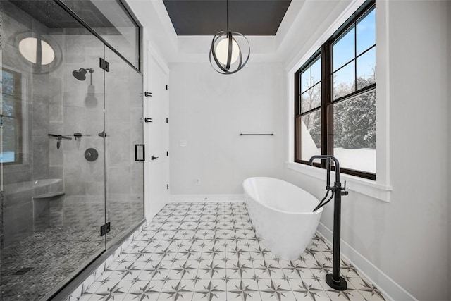 bathroom featuring a raised ceiling and plus walk in shower