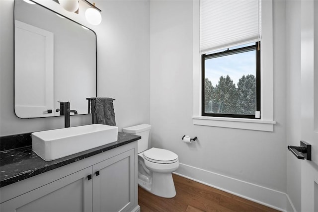 bathroom featuring hardwood / wood-style floors, toilet, and vanity