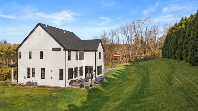 rear view of property with central AC, a lawn, and a patio