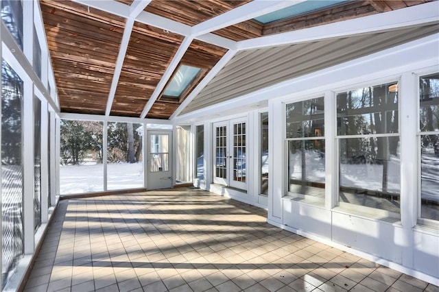 unfurnished sunroom featuring vaulted ceiling and french doors