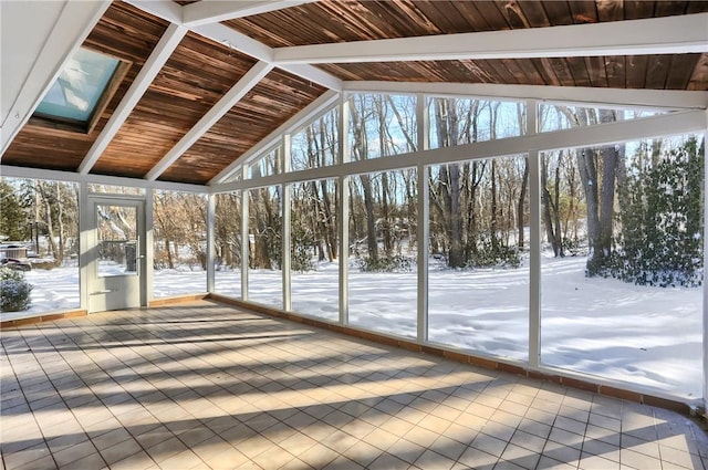 unfurnished sunroom with a wealth of natural light and lofted ceiling with skylight