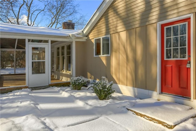 view of snow covered property entrance