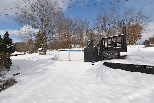 yard layered in snow with a deck