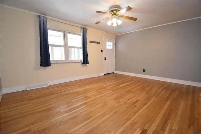 empty room featuring ceiling fan, ornamental molding, and light hardwood / wood-style floors