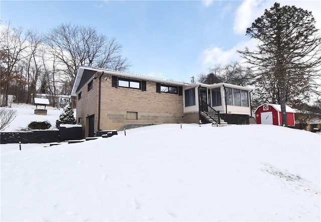 snow covered house with a sunroom