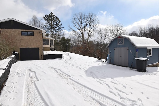 snowy yard with a garage