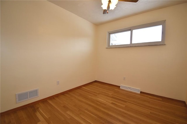 empty room with hardwood / wood-style flooring and ceiling fan