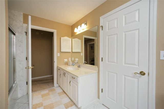 bathroom featuring vanity and bath / shower combo with glass door