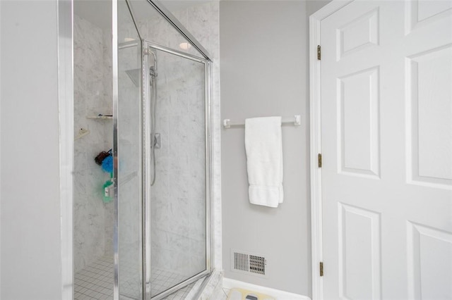 bathroom with a shower with shower door