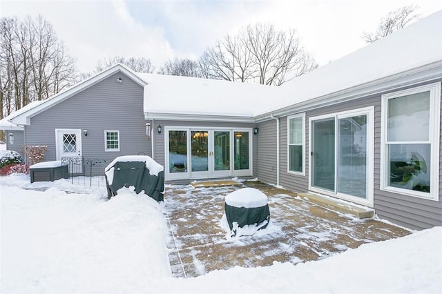 view of snow covered rear of property