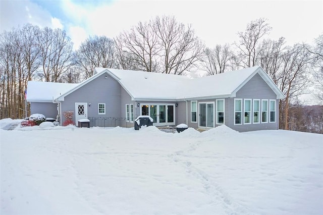 view of snow covered rear of property