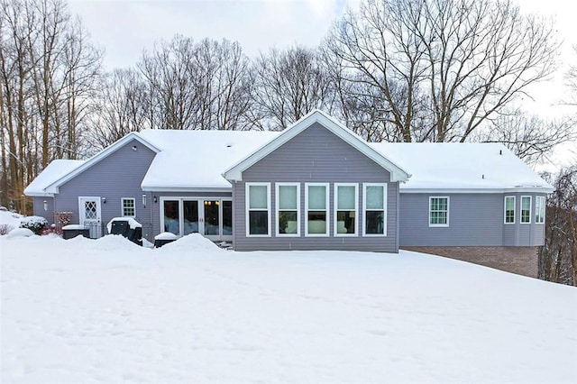 view of snow covered rear of property