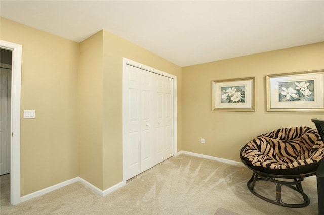 living area featuring light colored carpet