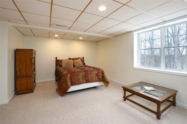 carpeted bedroom with a paneled ceiling