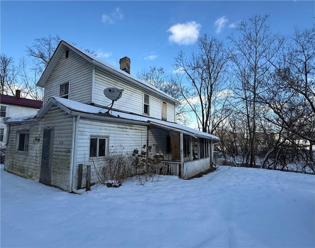 view of snow covered exterior with a porch