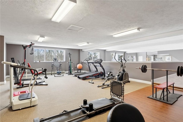 workout area featuring a textured ceiling and hardwood / wood-style flooring