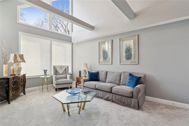 carpeted living room featuring a high ceiling and beamed ceiling