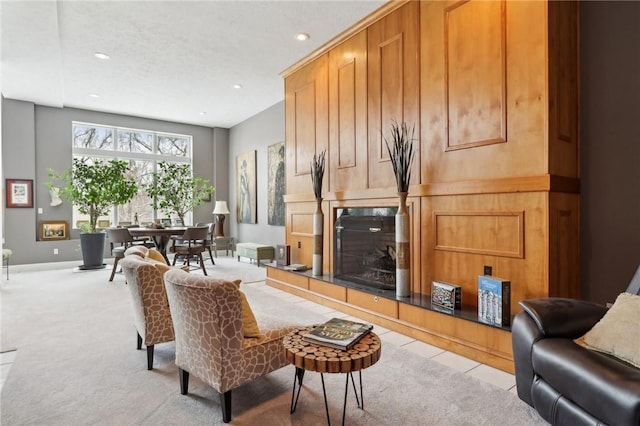 carpeted living room with a tile fireplace