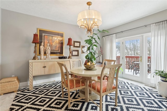 dining area with a textured ceiling and an inviting chandelier