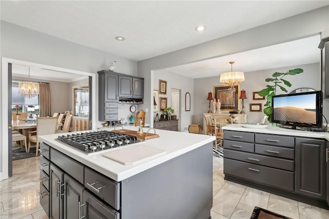 kitchen with an inviting chandelier, gray cabinetry, and decorative light fixtures