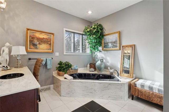 bathroom featuring a tub, tile patterned flooring, and vanity