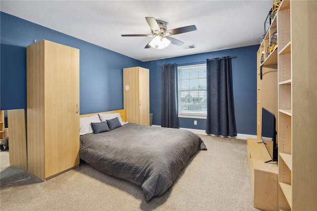 bedroom featuring light carpet and ceiling fan