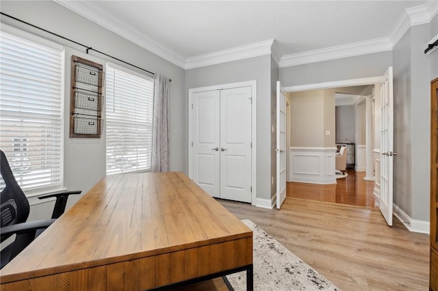 office space with crown molding and light wood-type flooring