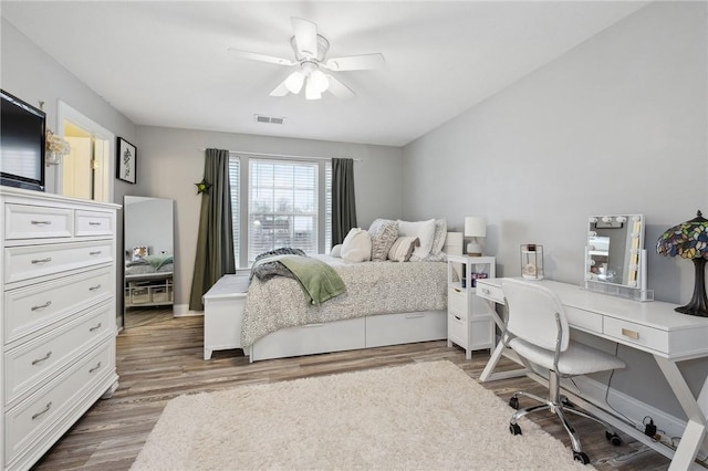 bedroom with ceiling fan and dark hardwood / wood-style flooring