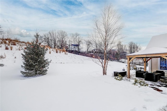 yard covered in snow with a gazebo