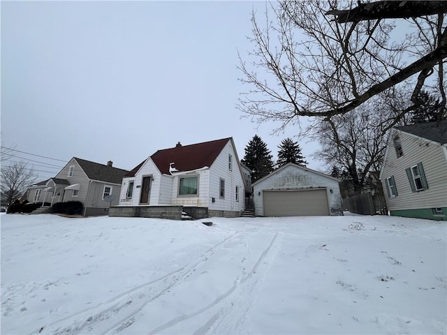 view of front of property featuring a garage and an outdoor structure