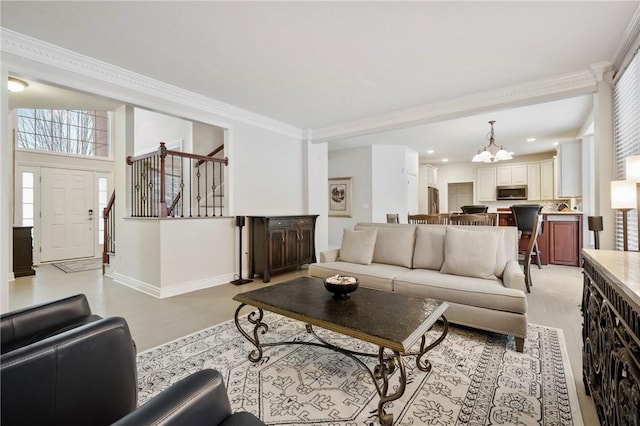 living room featuring ornamental molding and a chandelier