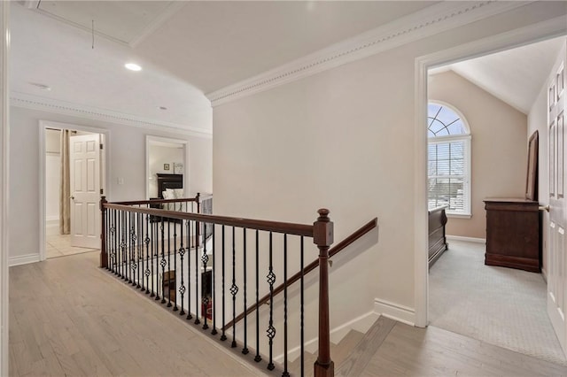 corridor with vaulted ceiling and light hardwood / wood-style floors