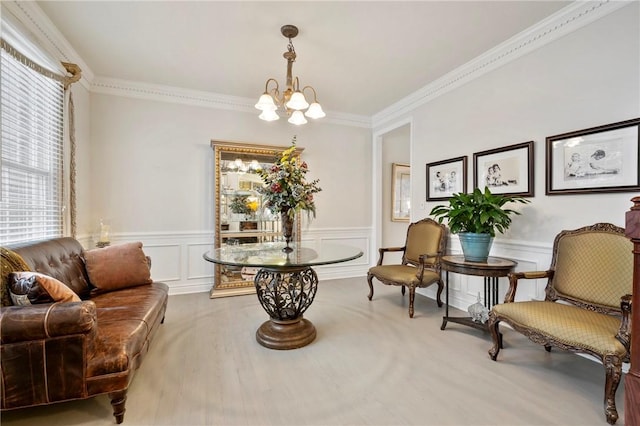 sitting room featuring a chandelier and ornamental molding