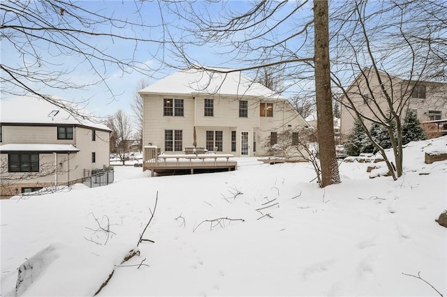 snow covered property featuring a deck