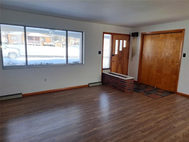 foyer with baseboard heating and dark hardwood / wood-style flooring