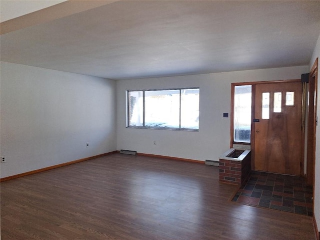 foyer with baseboard heating and dark wood-type flooring