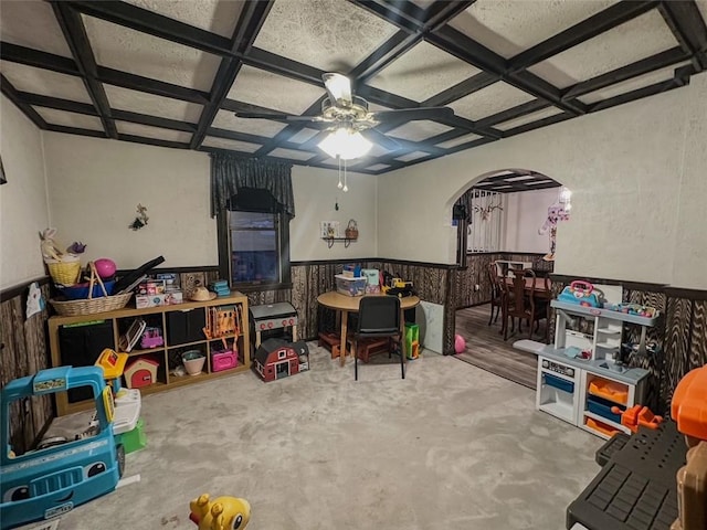 rec room with ceiling fan, beamed ceiling, and coffered ceiling