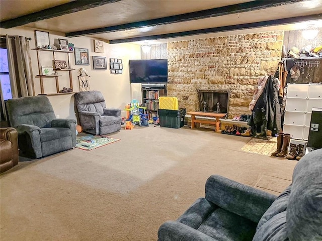 carpeted living room featuring beam ceiling and a fireplace