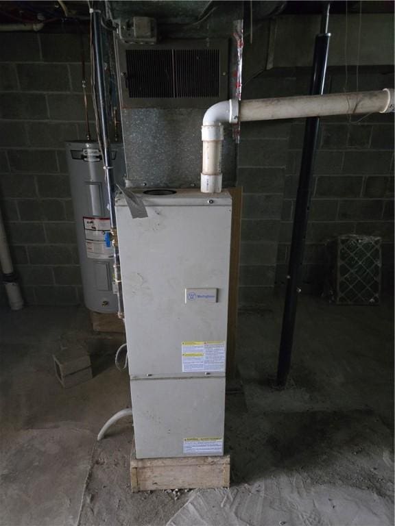 utility room featuring water heater