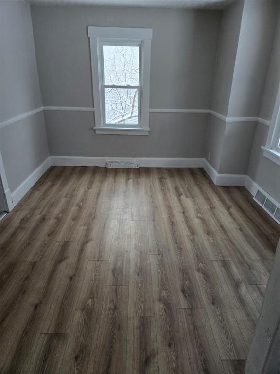 unfurnished room featuring hardwood / wood-style floors