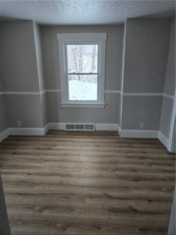 empty room with dark wood-type flooring